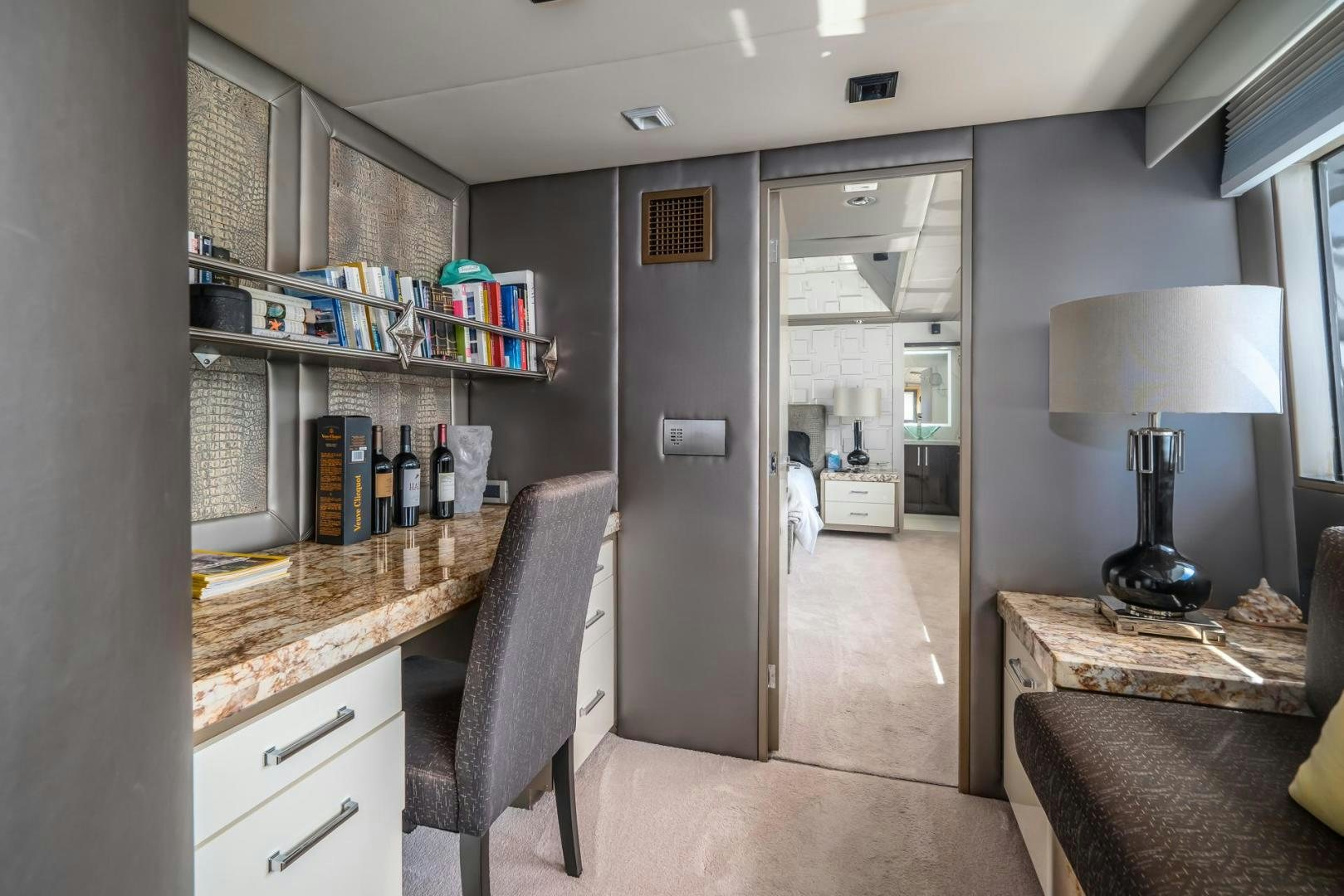 a room with a desk and a lamp aboard SOVEREIGN LADY Yacht for Sale