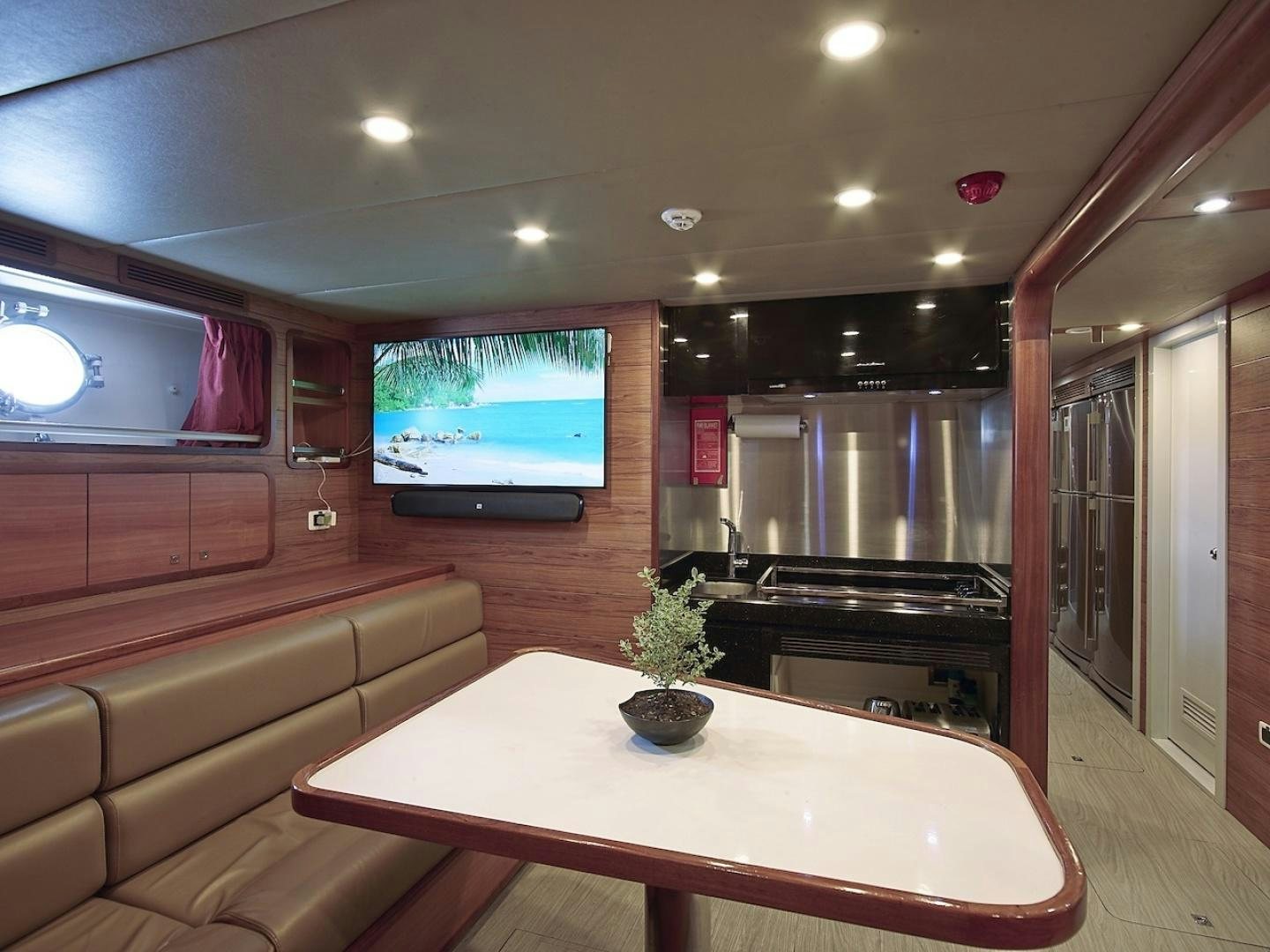 a large room with a tv and a table aboard ALAIA Yacht for Sale