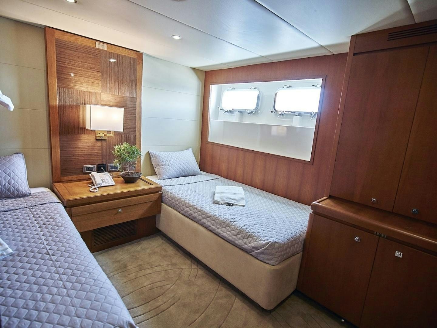 a bedroom with two beds aboard ALAIA Yacht for Sale