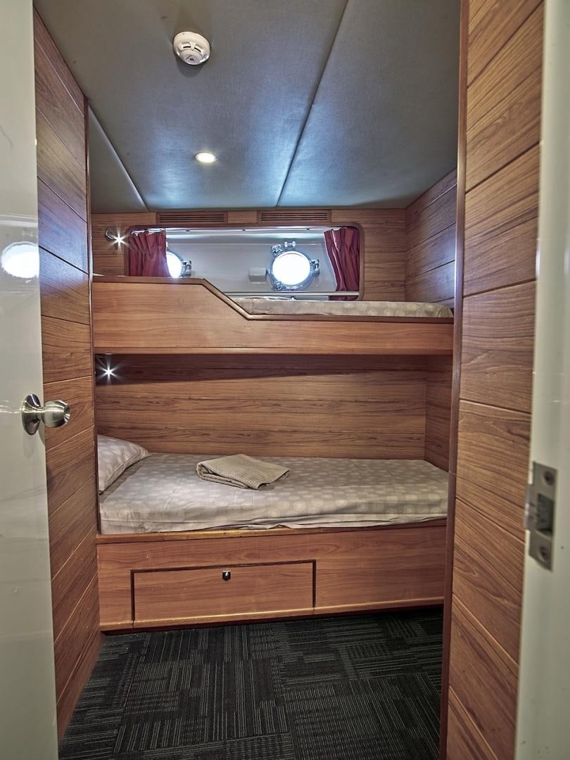 a wooden bunk bed aboard ALAIA Yacht for Sale