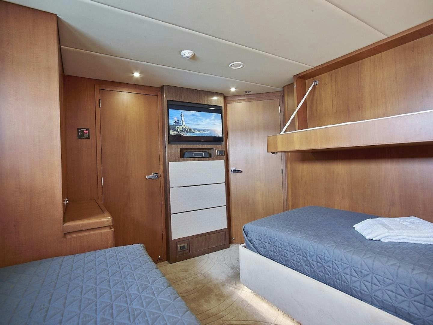 a room with a bed and a closet aboard ALAIA Yacht for Sale