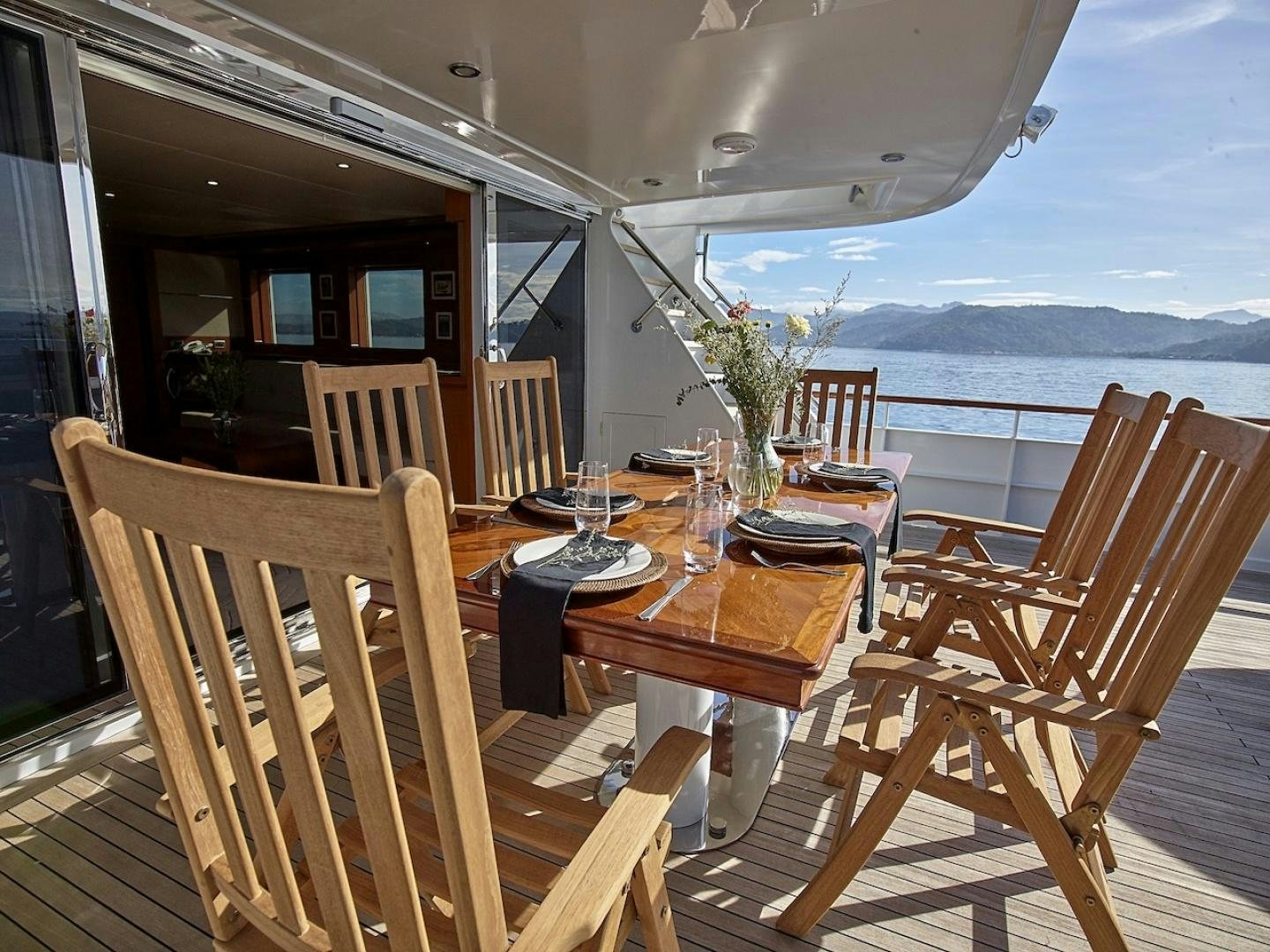 a table and chairs on a deck aboard ALAIA Yacht for Sale