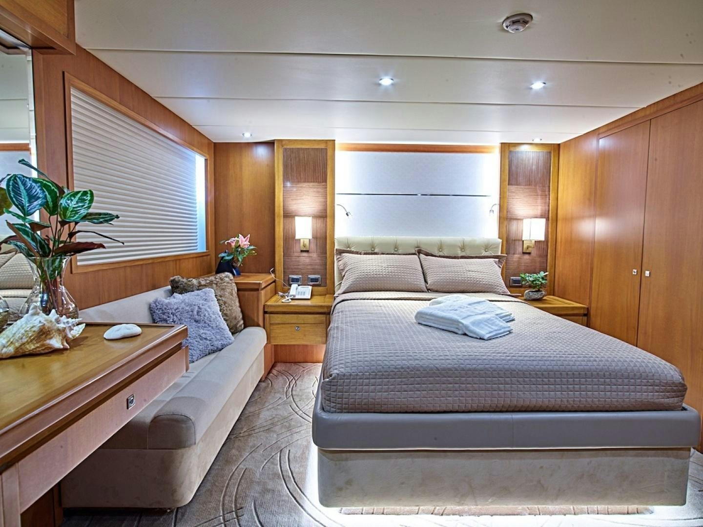 a bedroom with a bed and a desk aboard ALAIA Yacht for Sale
