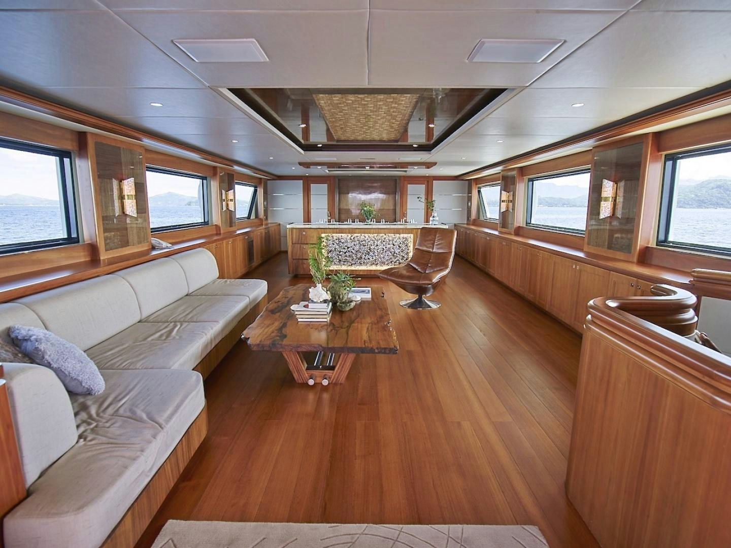 a living room with a wood floor aboard ALAIA Yacht for Sale