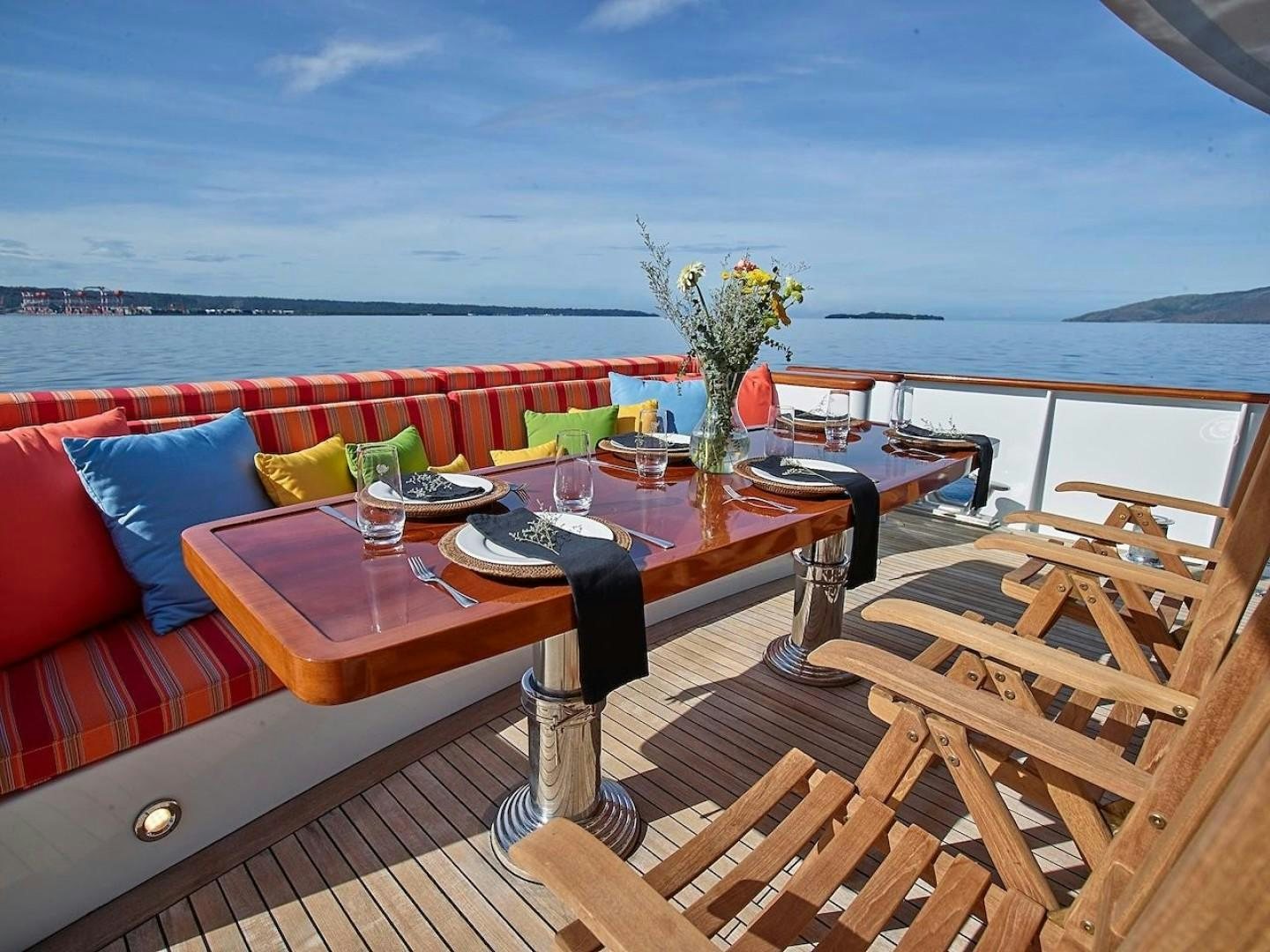 a table on a deck aboard ALAIA Yacht for Sale
