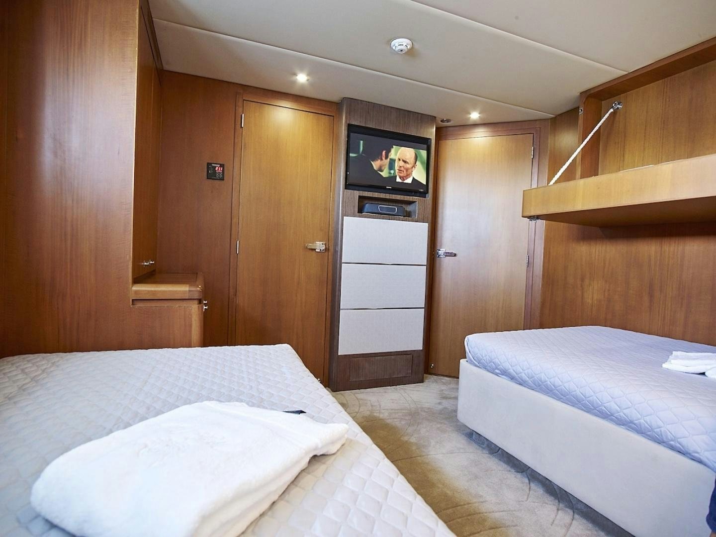 a bedroom with a bed and a television aboard ALAIA Yacht for Sale