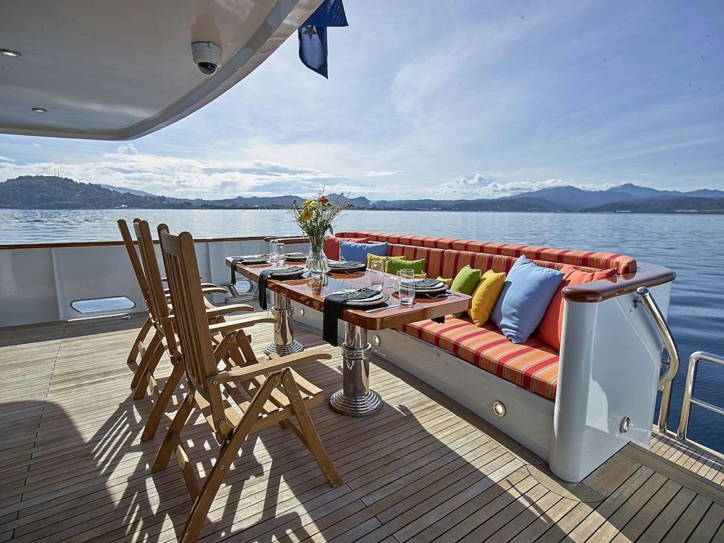 a balcony with a table and chairs aboard ALAIA Yacht for Sale