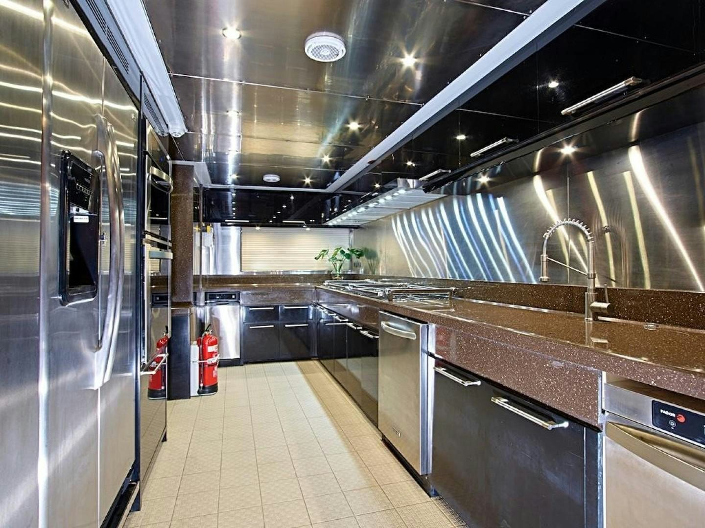 a large kitchen with stainless steel appliances aboard ALAIA Yacht for Sale