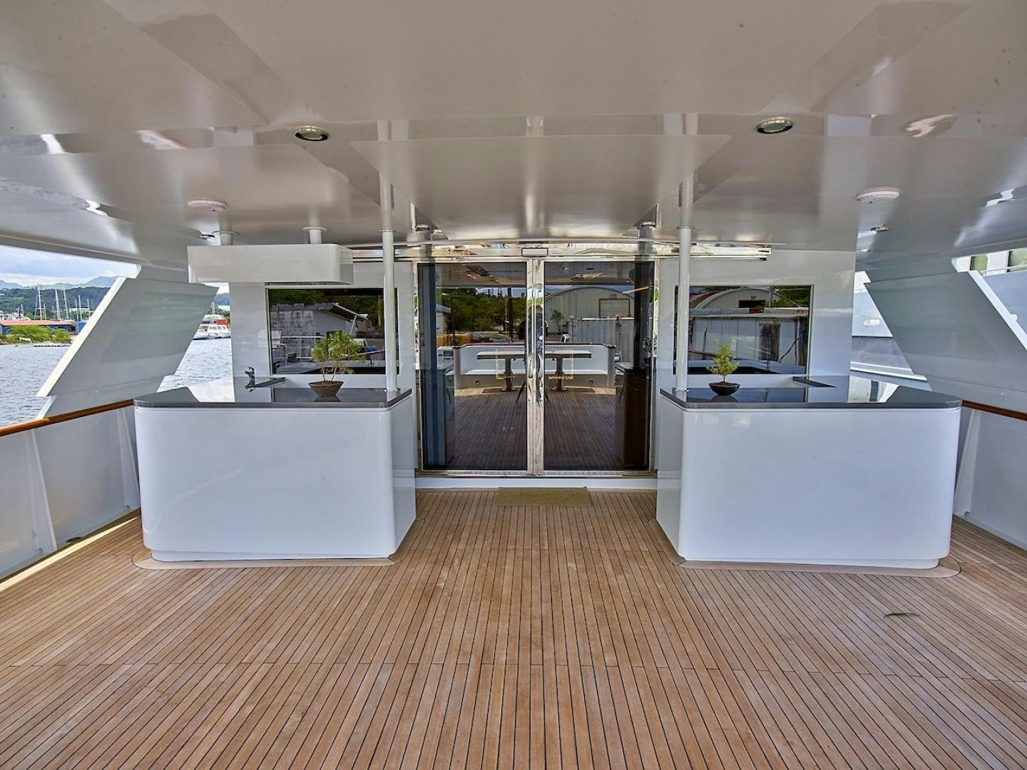 a room with glass doors and a wood floor aboard ALAIA Yacht for Sale