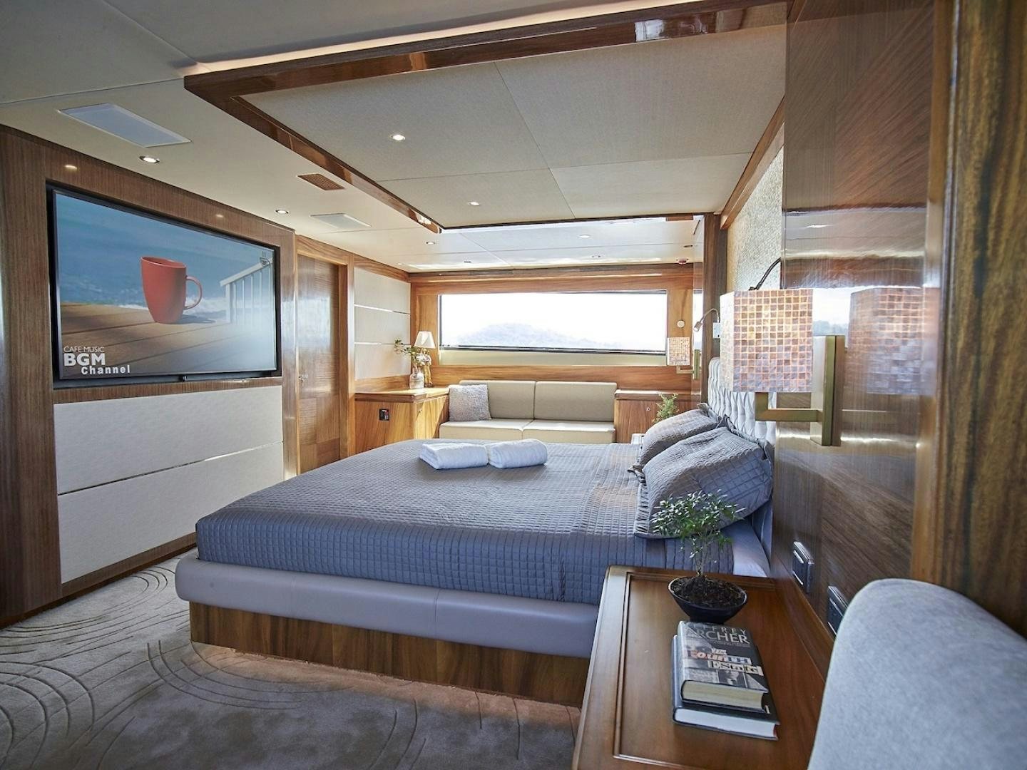 a bedroom with a bed and a tv aboard ALAIA Yacht for Sale