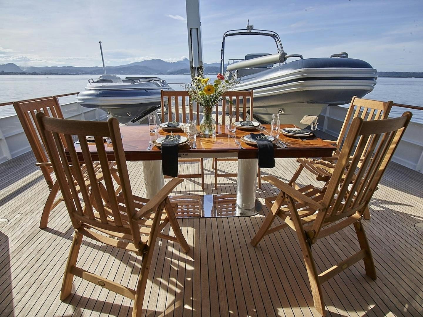 a table with chairs on it aboard ALAIA Yacht for Sale