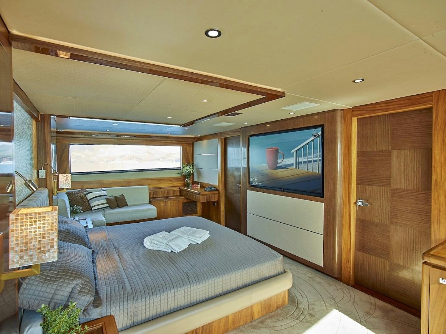 a room with a bed and a television aboard ALAIA Yacht for Sale