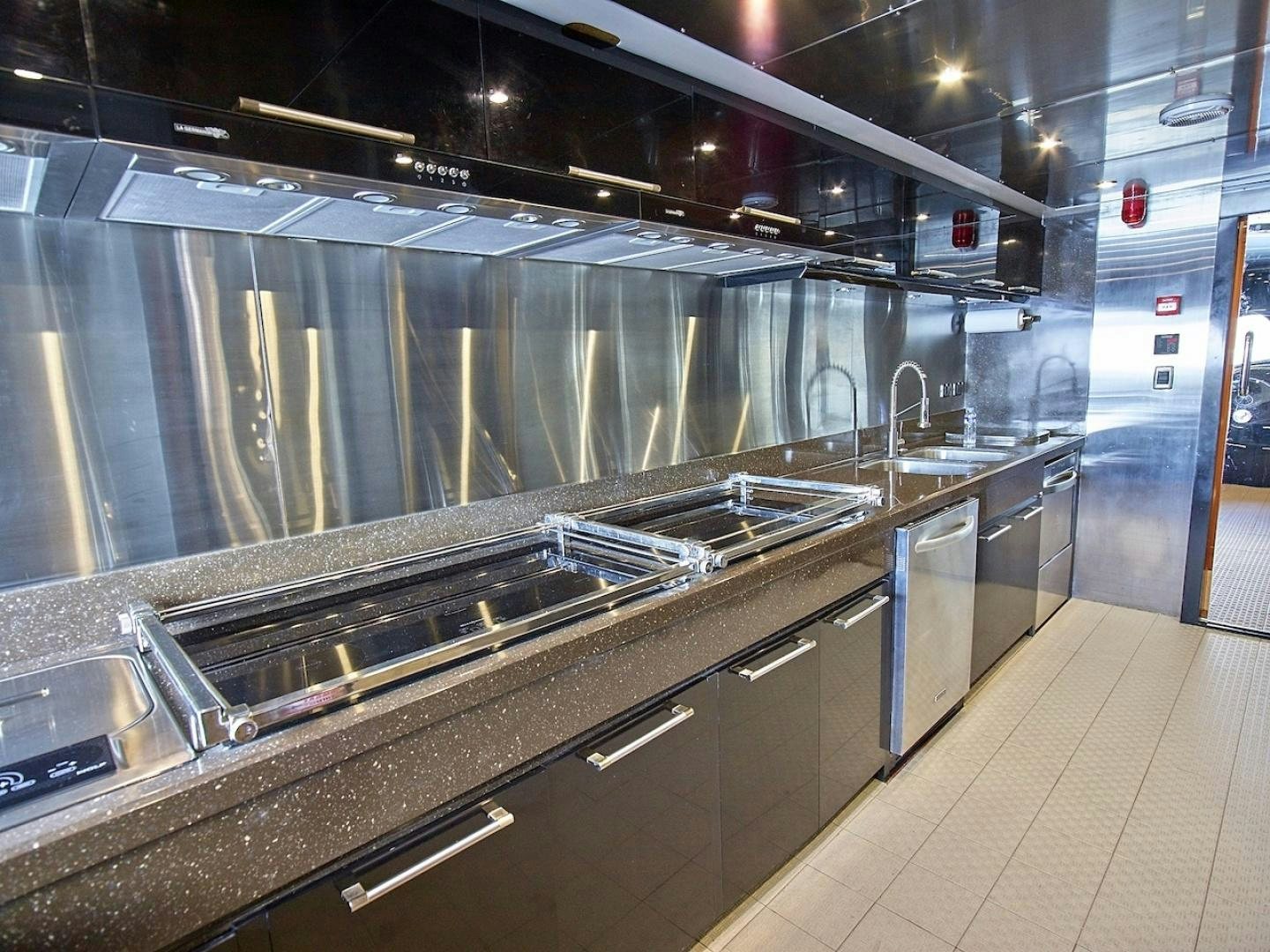 a large kitchen with stainless steel appliances aboard ALAIA Yacht for Sale