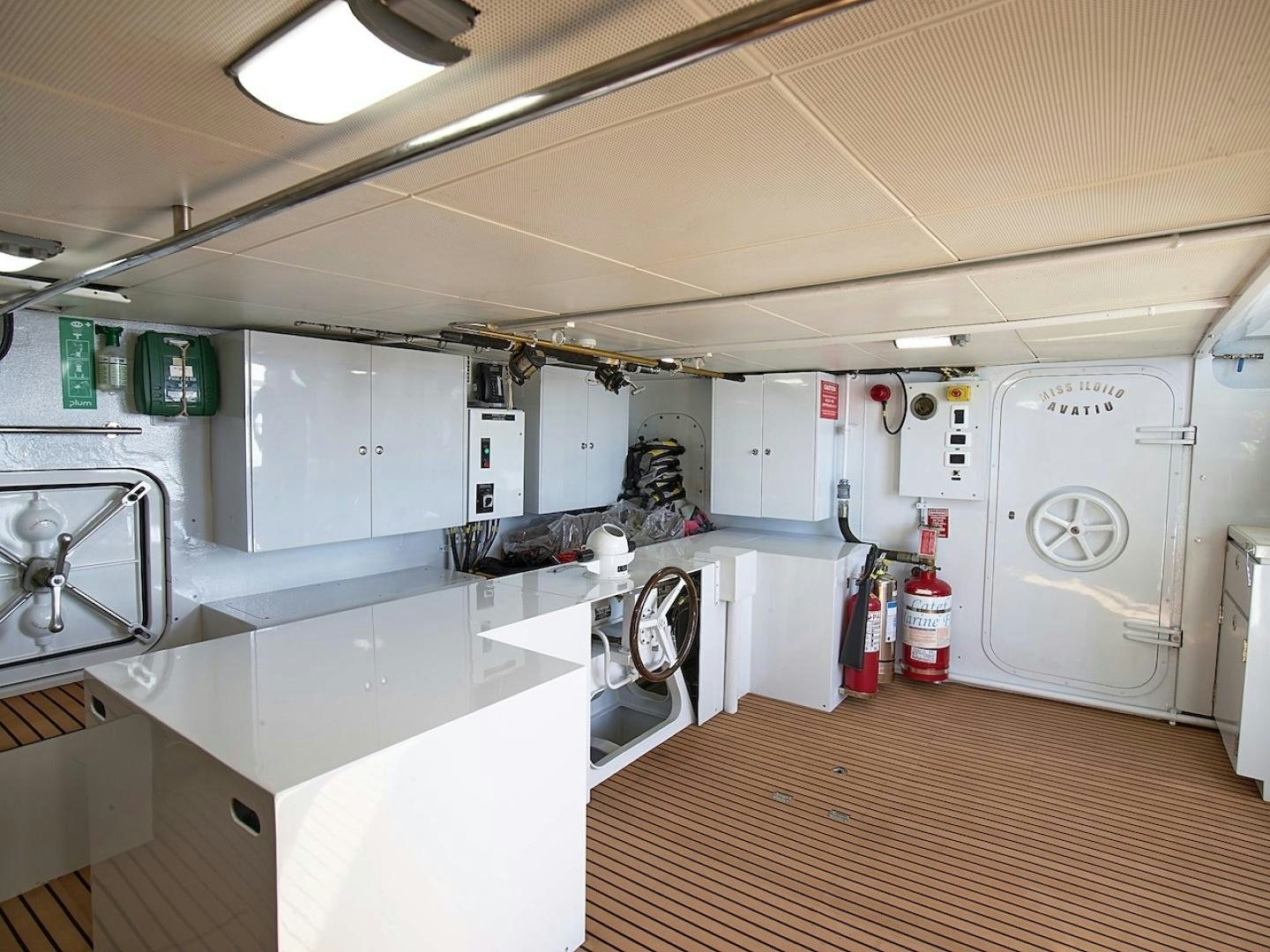 a room with white cabinets and a wood floor aboard ALAIA Yacht for Sale