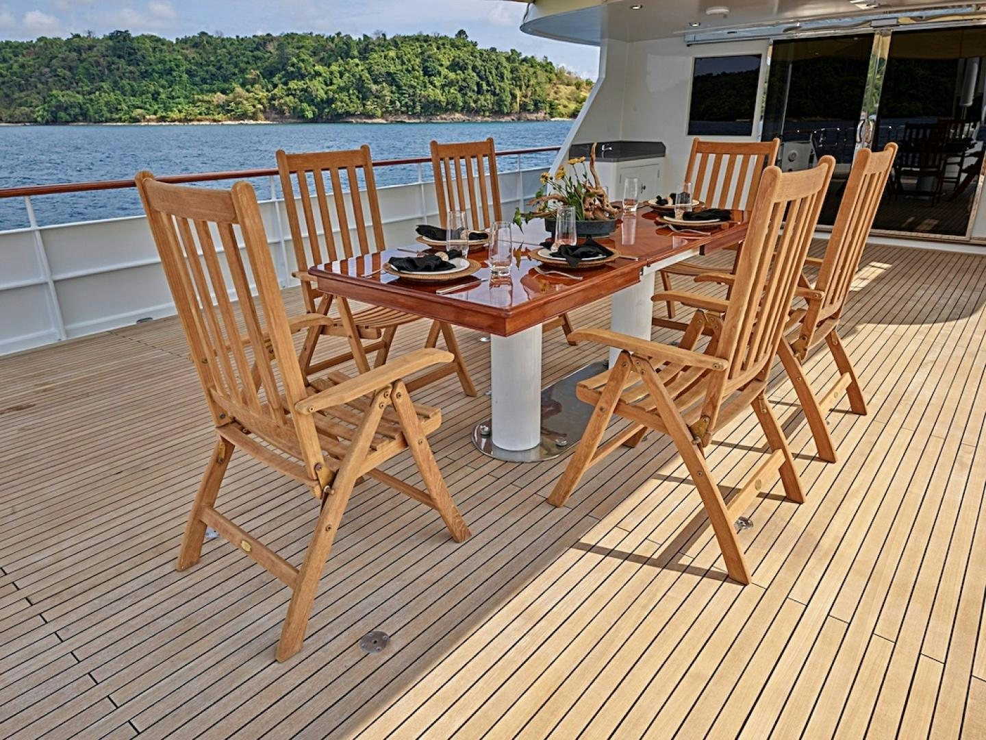 a table and chairs on a deck aboard ALAIA Yacht for Sale