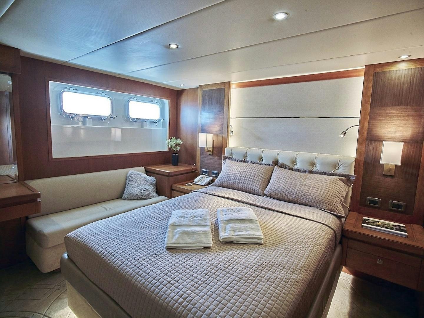 a bed with a white bed spread aboard ALAIA Yacht for Sale
