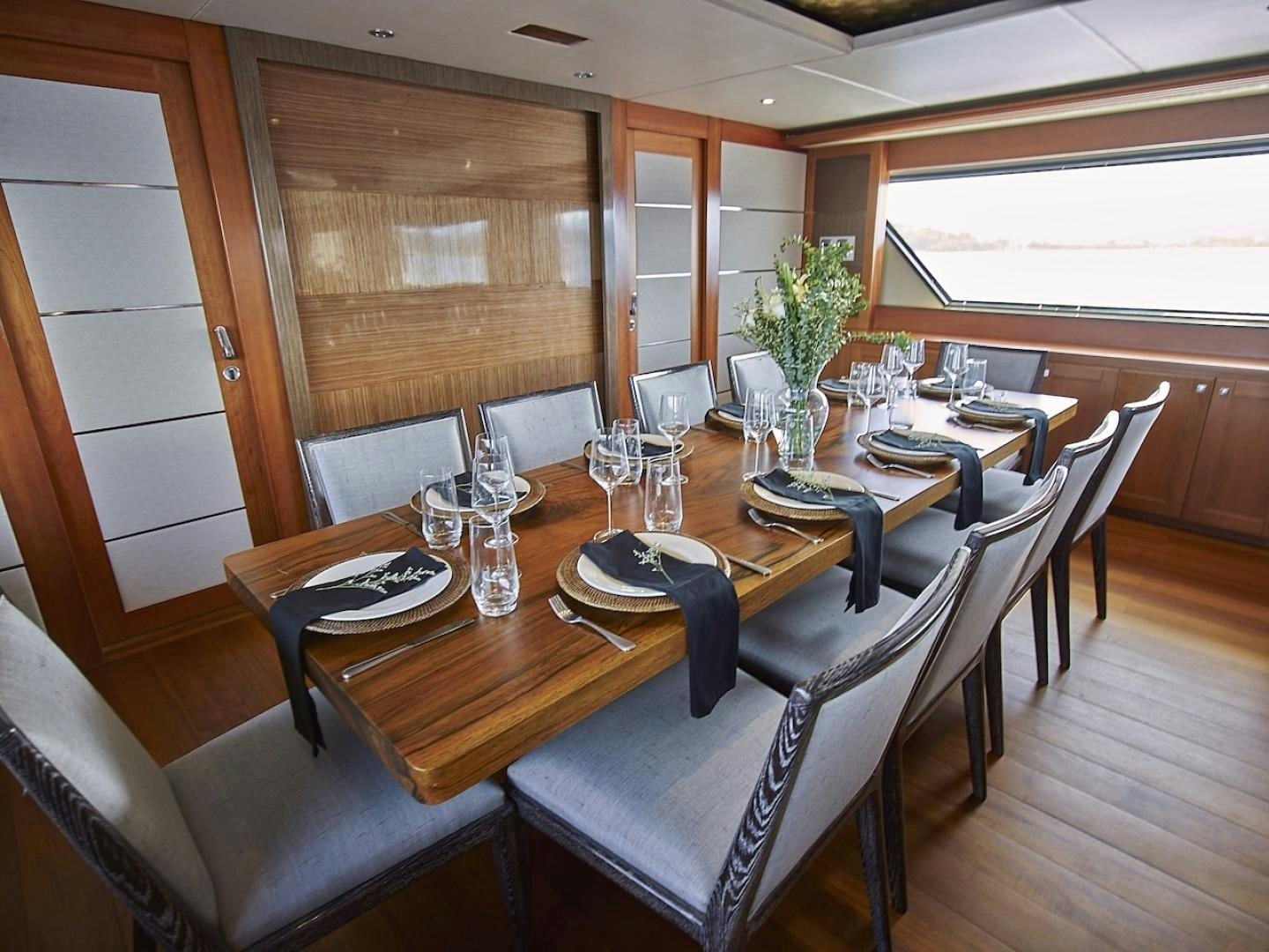 a dining table with chairs aboard ALAIA Yacht for Sale