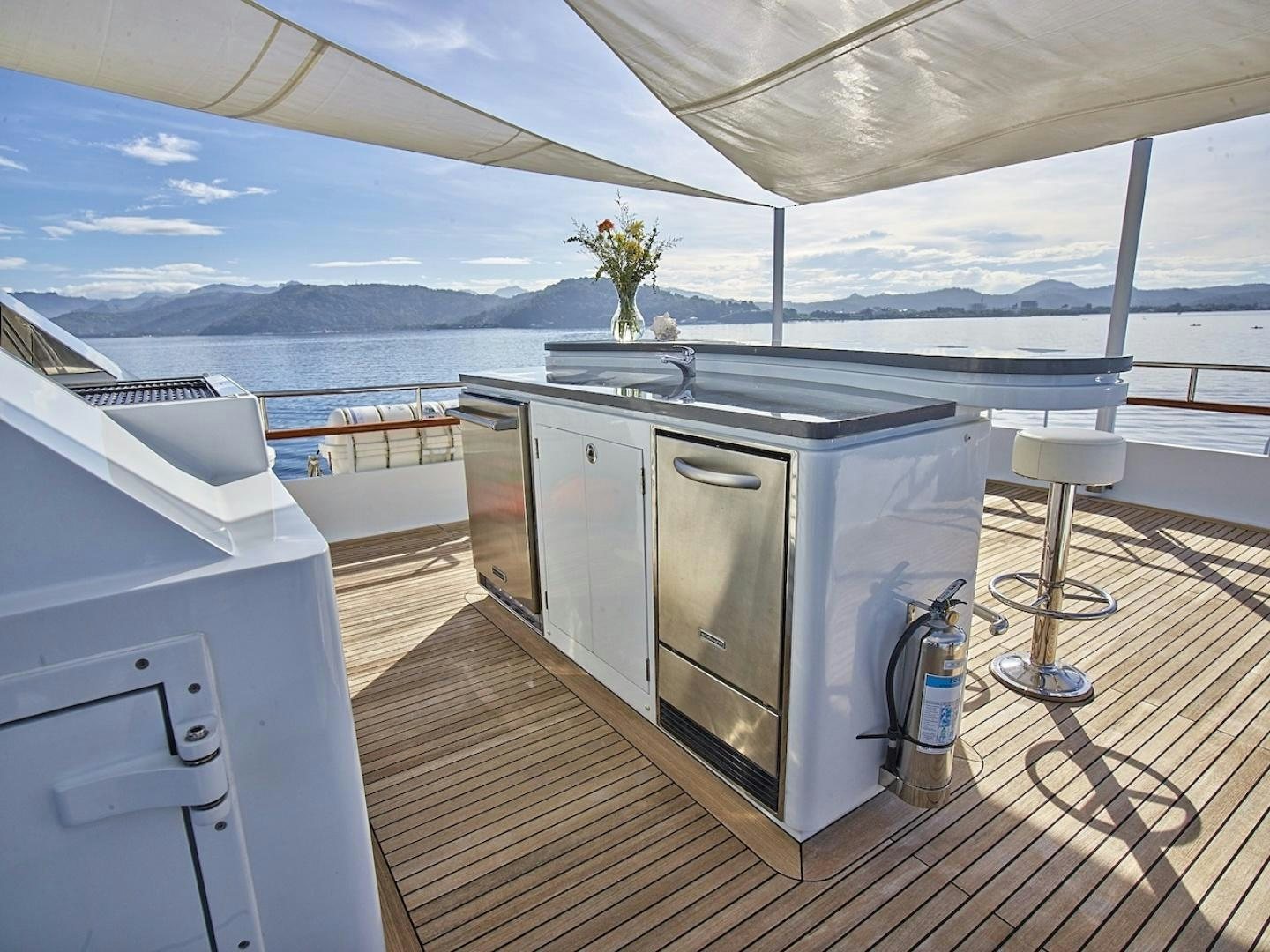 a kitchen with a large window overlooking the ocean aboard ALAIA Yacht for Sale