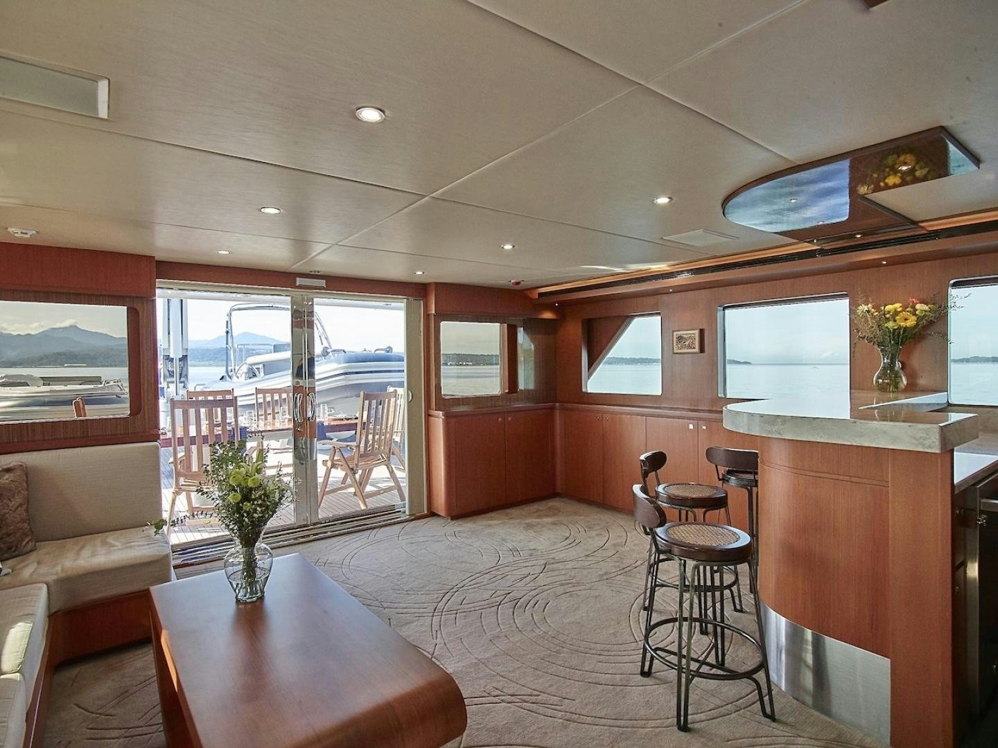 a living room with a table and chairs aboard ALAIA Yacht for Sale