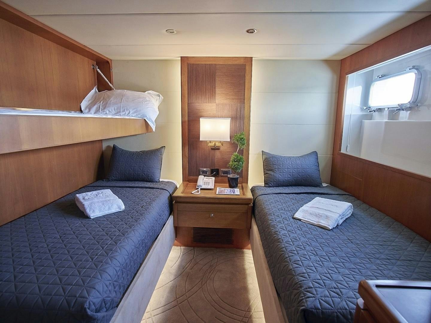 a couple of beds in a hotel room aboard ALAIA Yacht for Sale