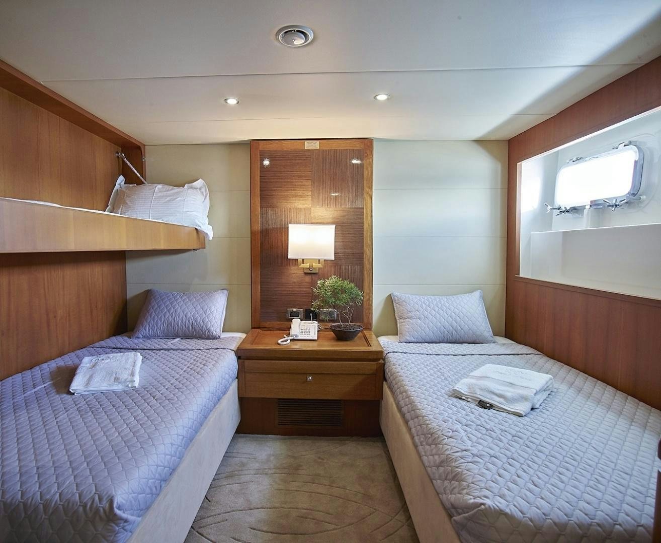 a hotel room with two beds aboard ALAIA Yacht for Sale