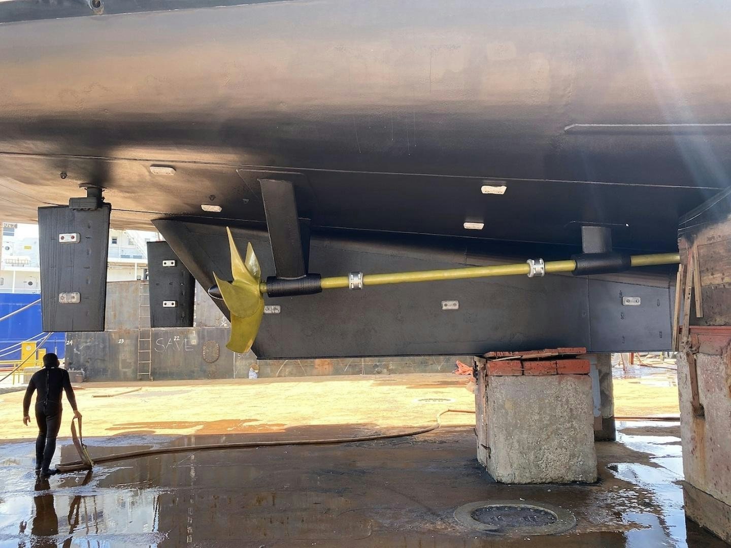 a person walking under a bridge aboard ALAIA Yacht for Sale