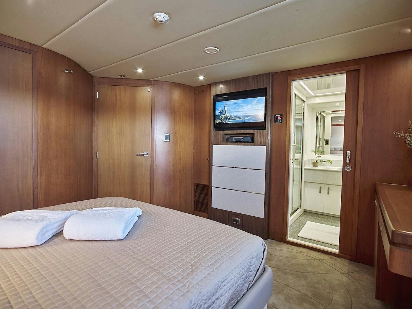 a bedroom with a bed and a television aboard ALAIA Yacht for Sale