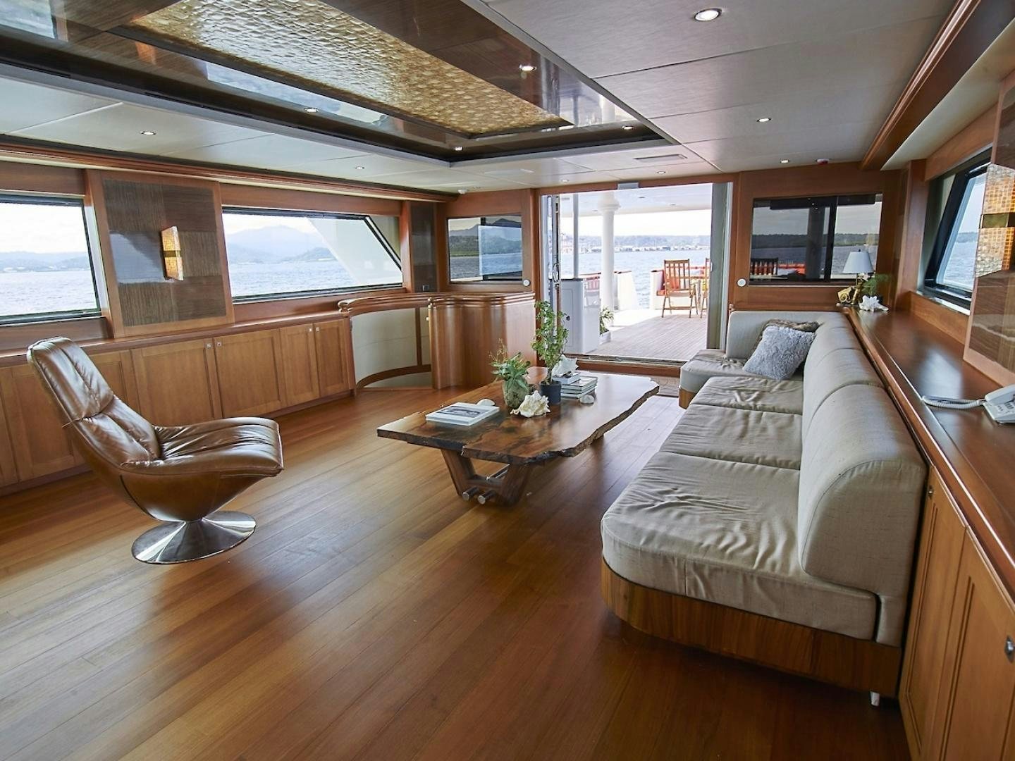 a living room with a wood floor aboard ALAIA Yacht for Sale