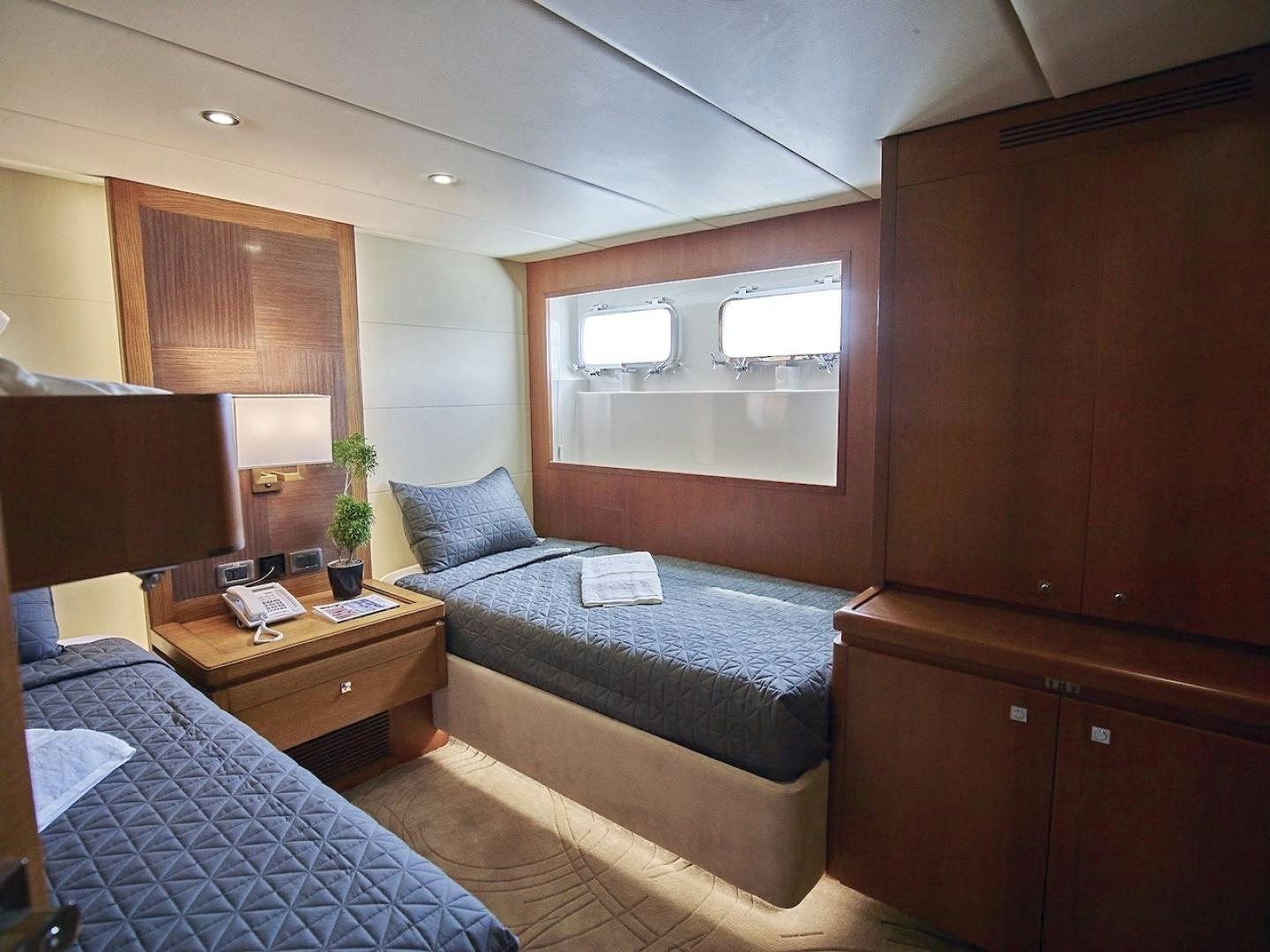 a bedroom with a bed and a desk aboard ALAIA Yacht for Sale