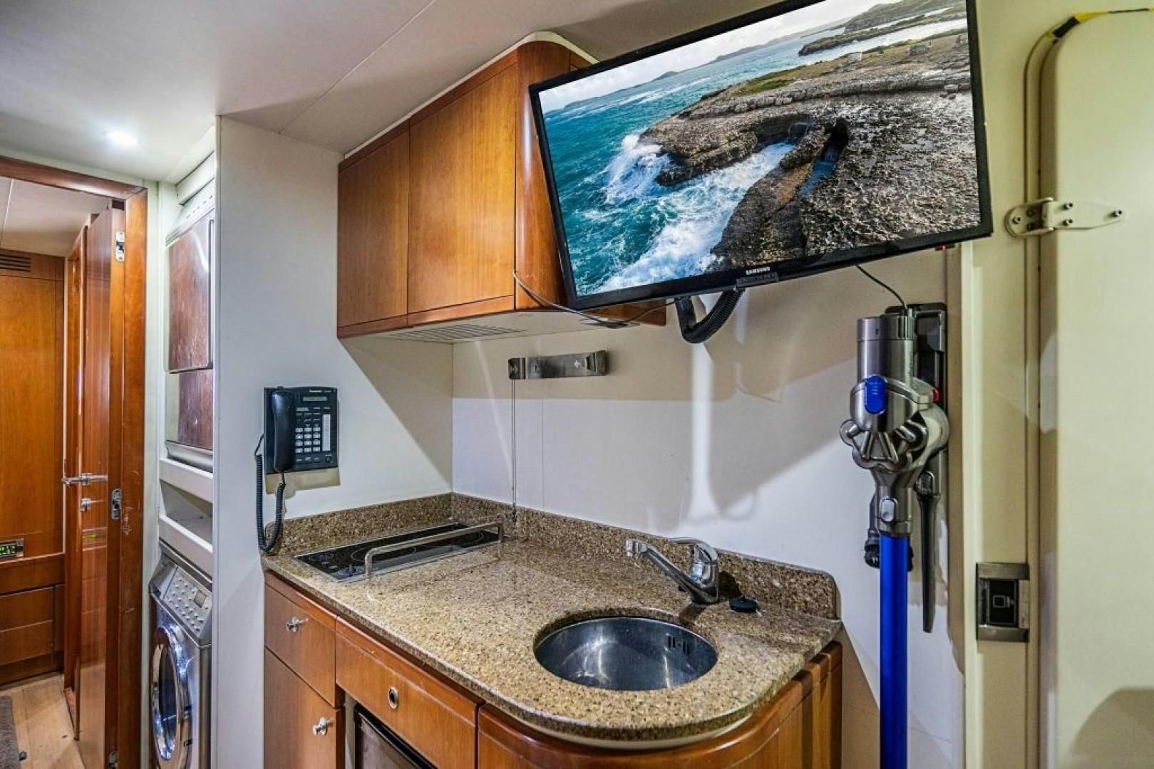 a kitchen with a sink and a fan aboard CINQUE MARE Yacht for Sale