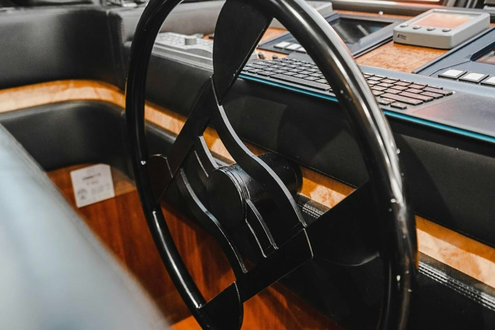 a black and white headphones on a black laptop aboard CINQUE MARE Yacht for Sale
