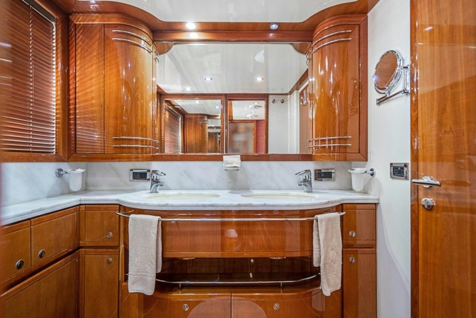 a kitchen with wooden cabinets aboard CINQUE MARE Yacht for Sale
