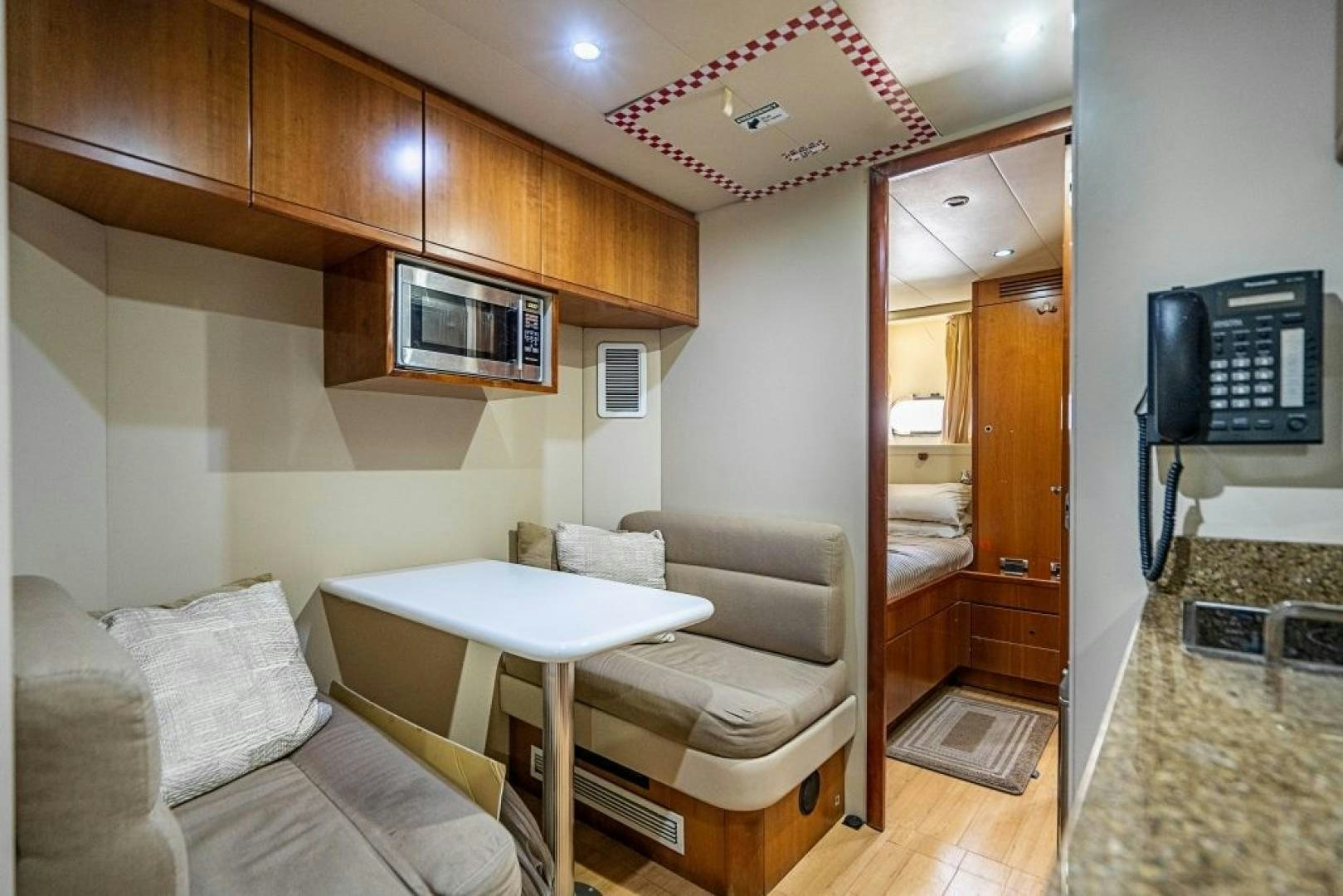 a living room with a table and couches aboard CINQUE MARE Yacht for Sale