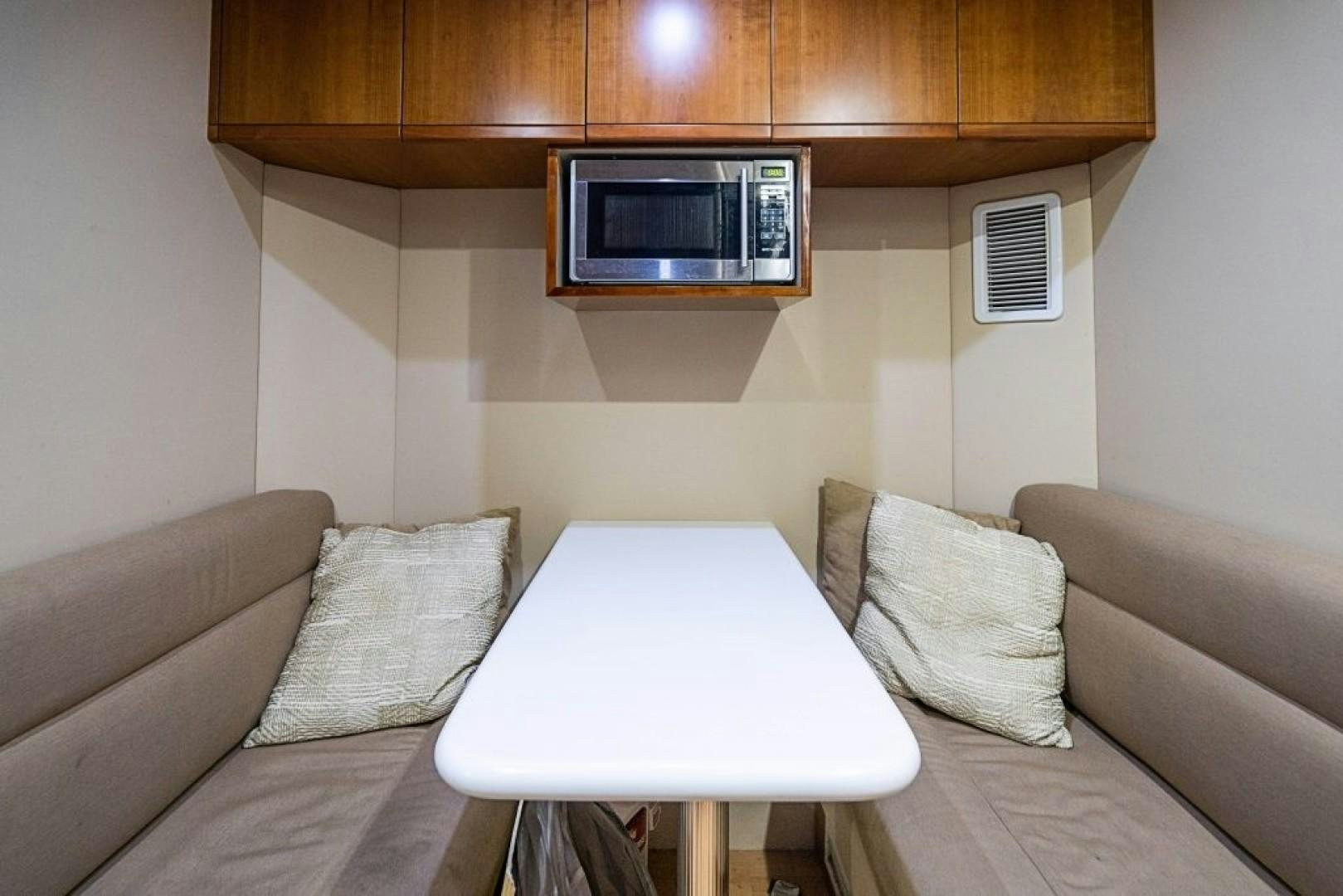 a living room with a couch and a table aboard CINQUE MARE Yacht for Sale