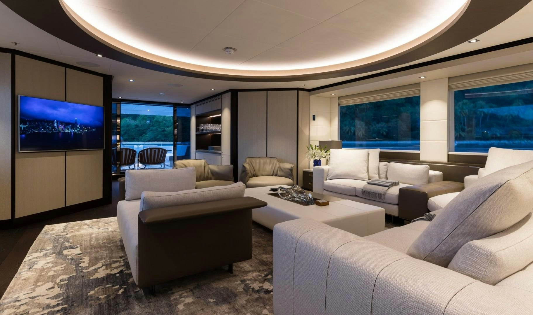 a living room with a large screen aboard LAURENTIA Yacht for Sale