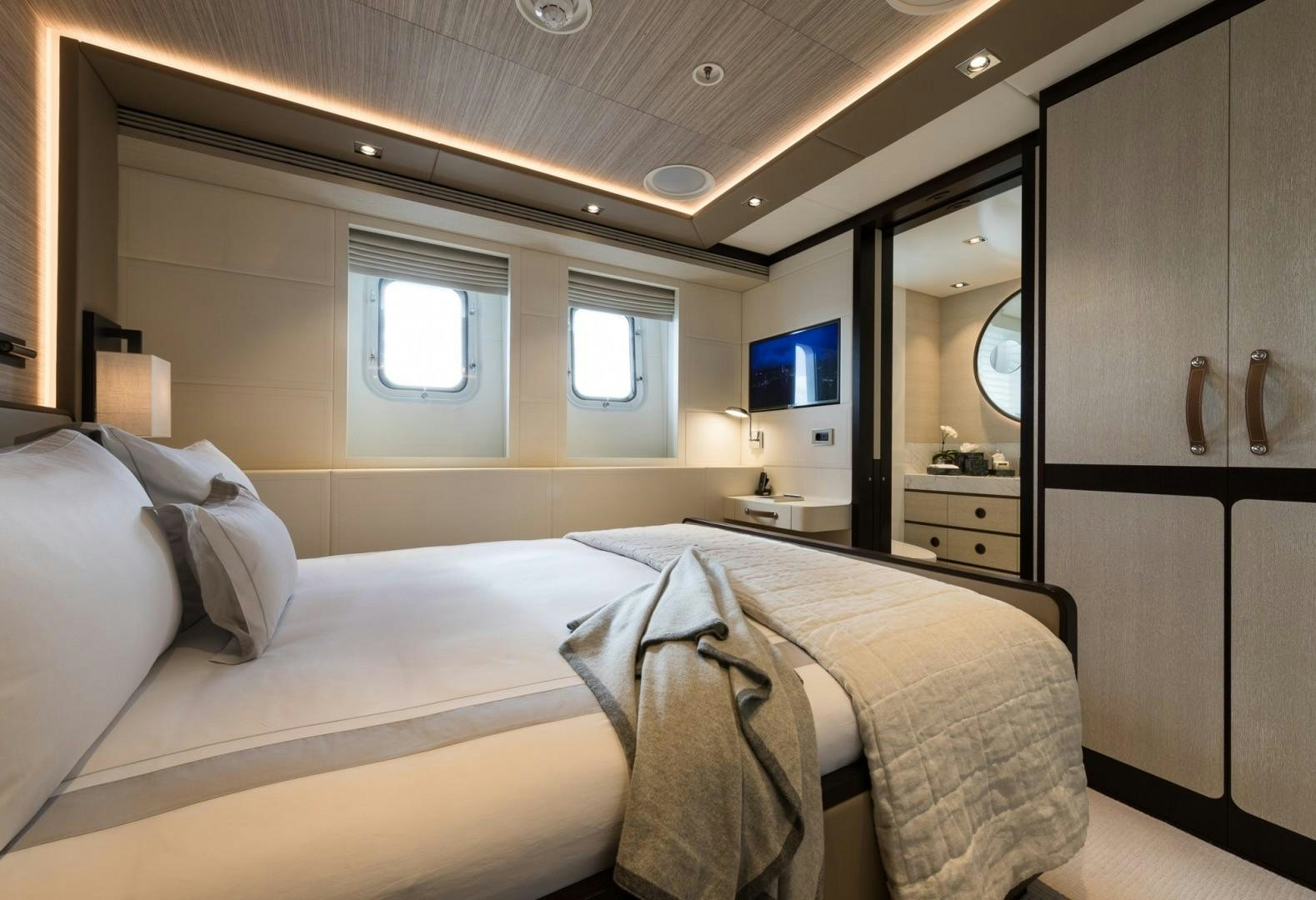 a room with a bed and a television aboard LAURENTIA Yacht for Sale
