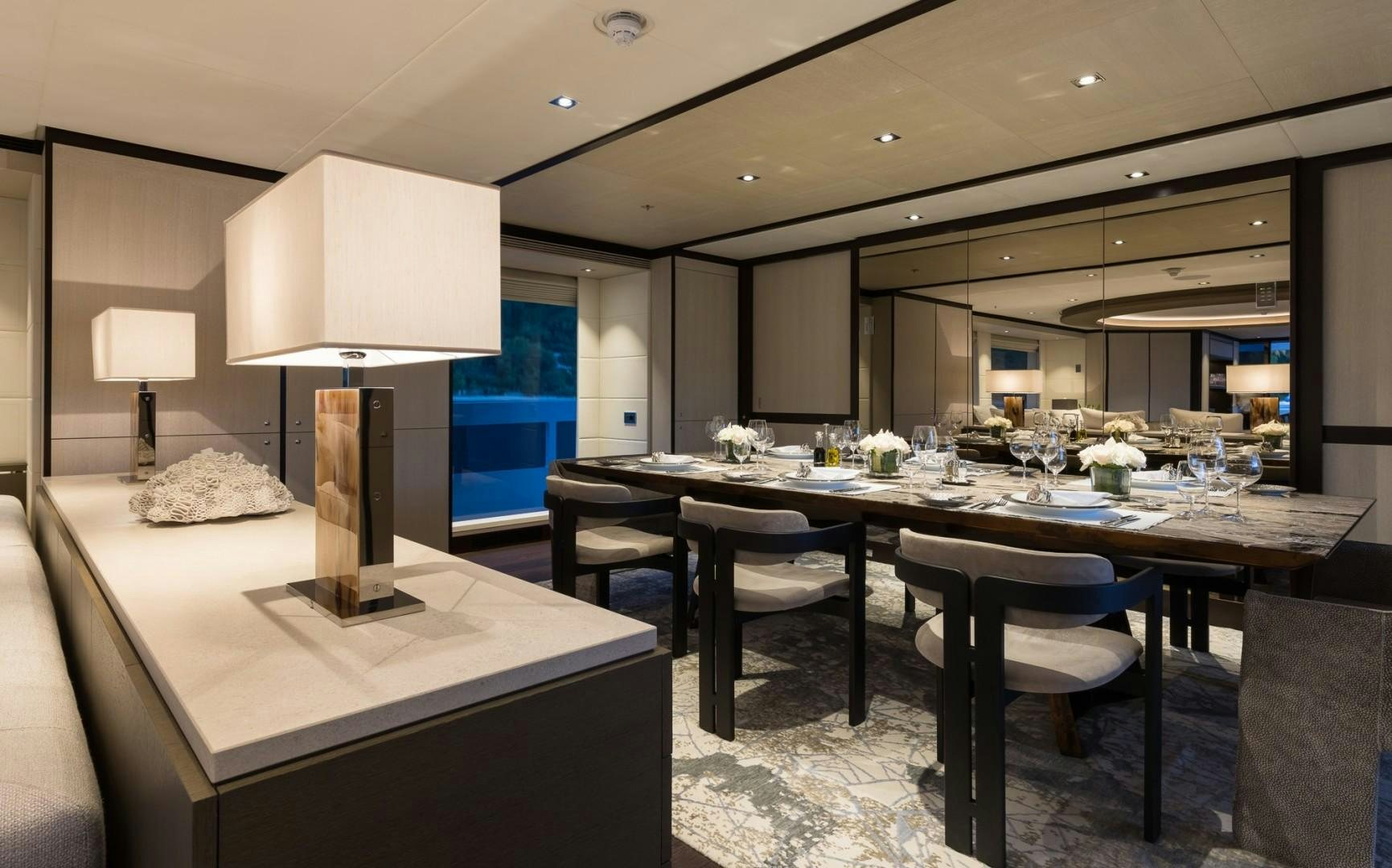 a room with a table and chairs aboard LAURENTIA Yacht for Sale