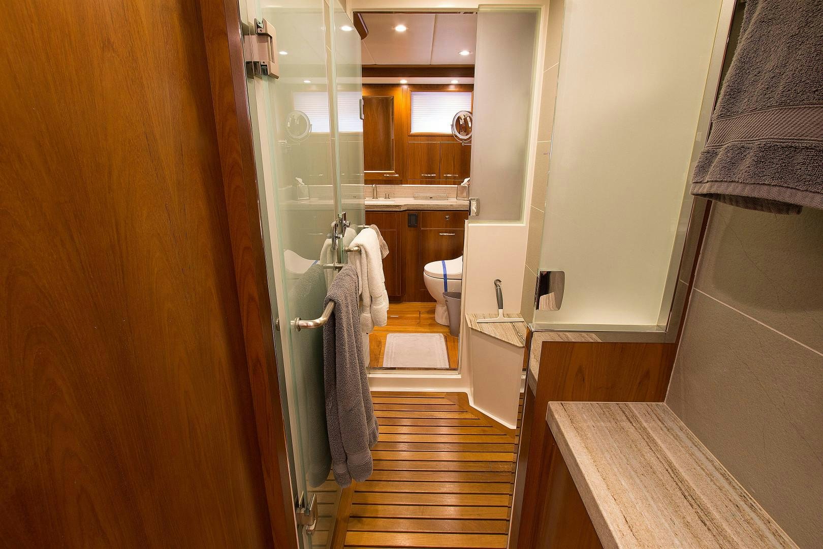 a bathroom with a wood door aboard LET IT BEE Yacht for Sale