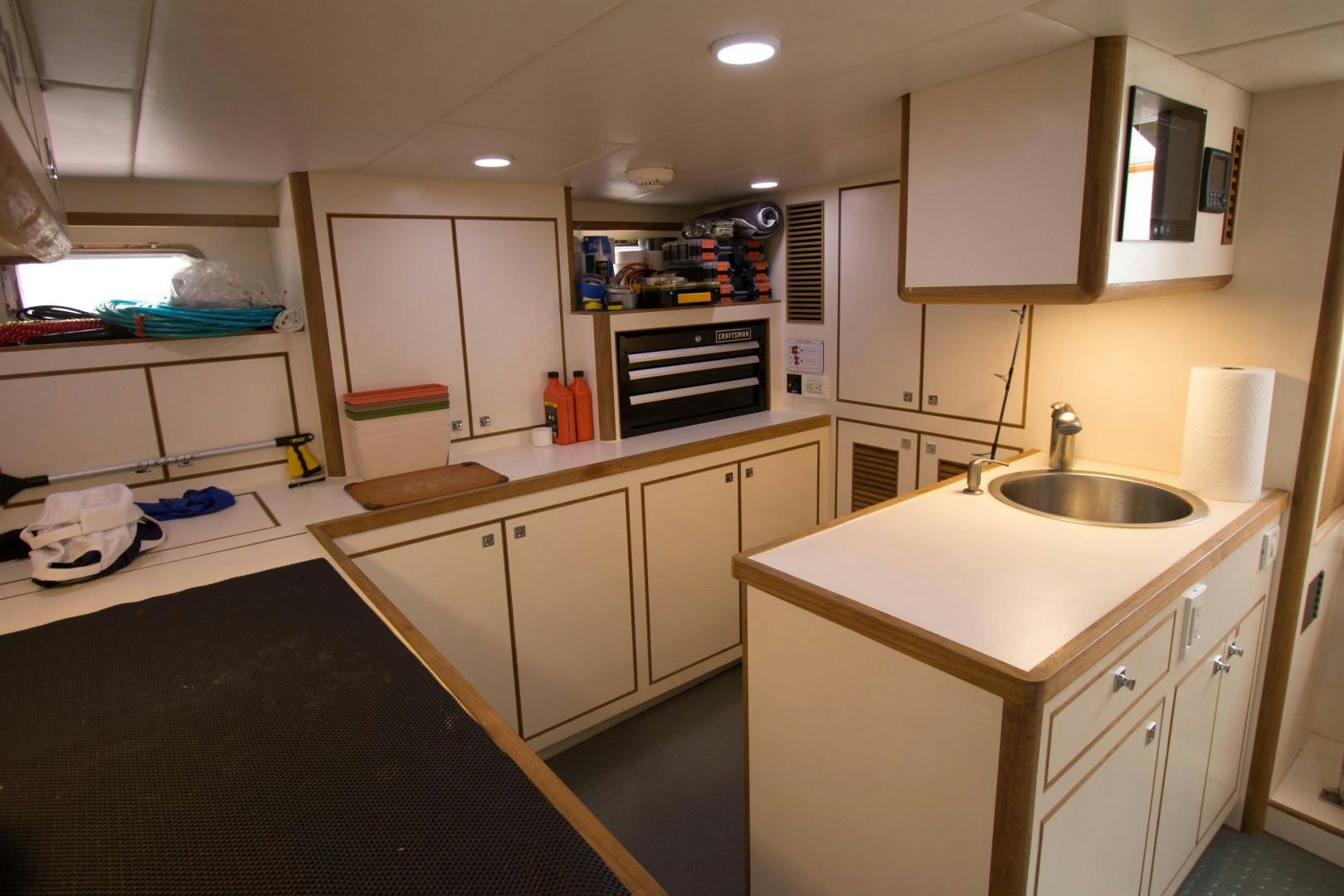 a kitchen with white cabinets aboard LET IT BEE Yacht for Sale
