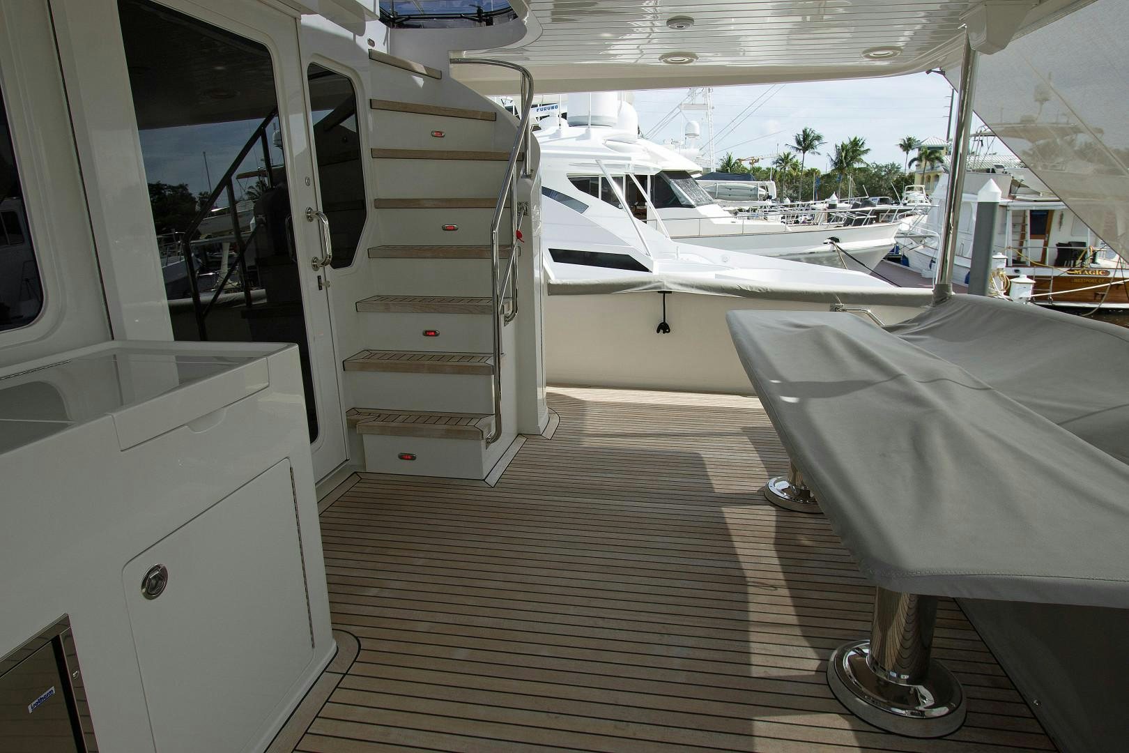 a room with a couple of white machines and a wood floor aboard LET IT BEE Yacht for Sale