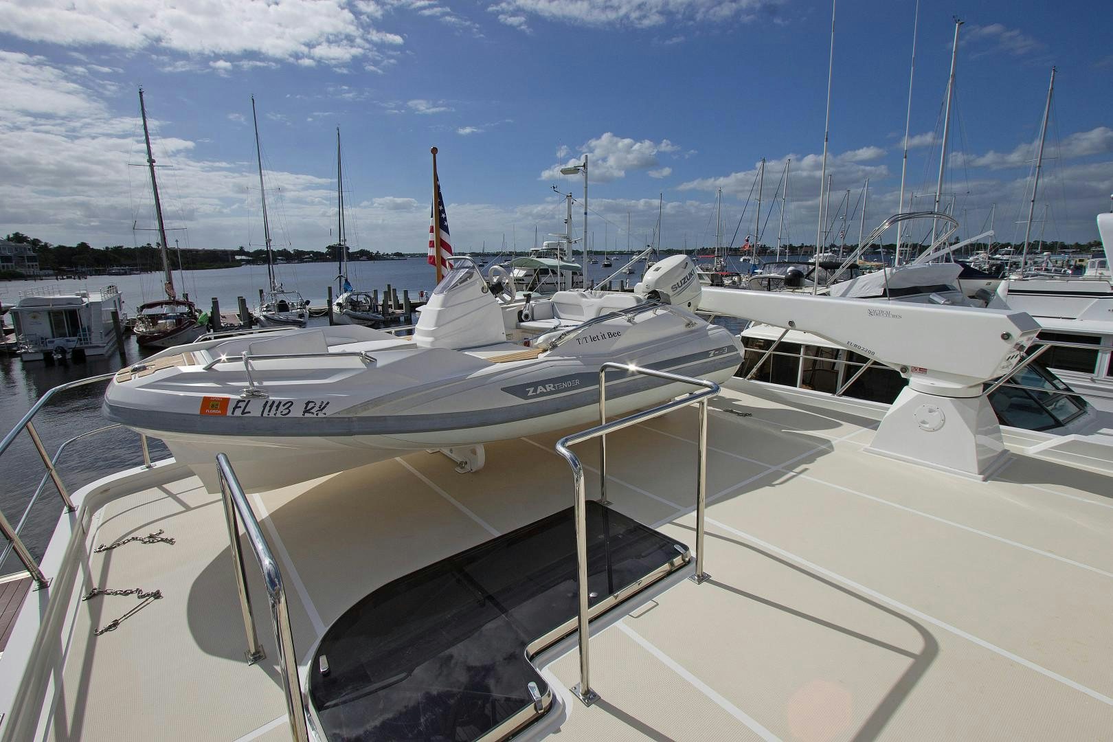 a group of boats are parked in a harbor aboard LET IT BEE Yacht for Sale