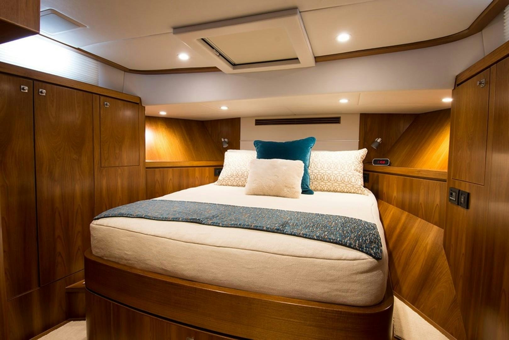 a bed with white sheets aboard LET IT BEE Yacht for Sale