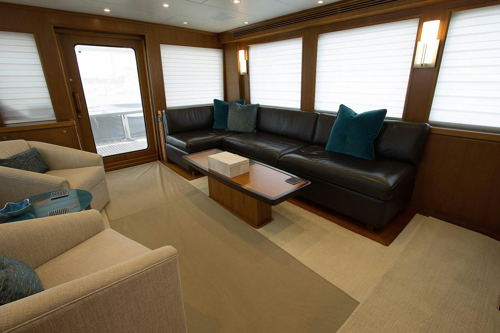 a living room with a couch and a coffee table aboard LET IT BEE Yacht for Sale
