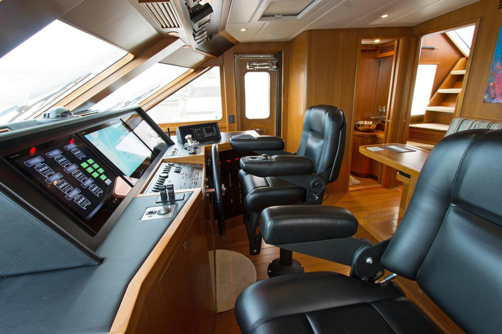 a room with computers and chairs aboard LET IT BEE Yacht for Sale