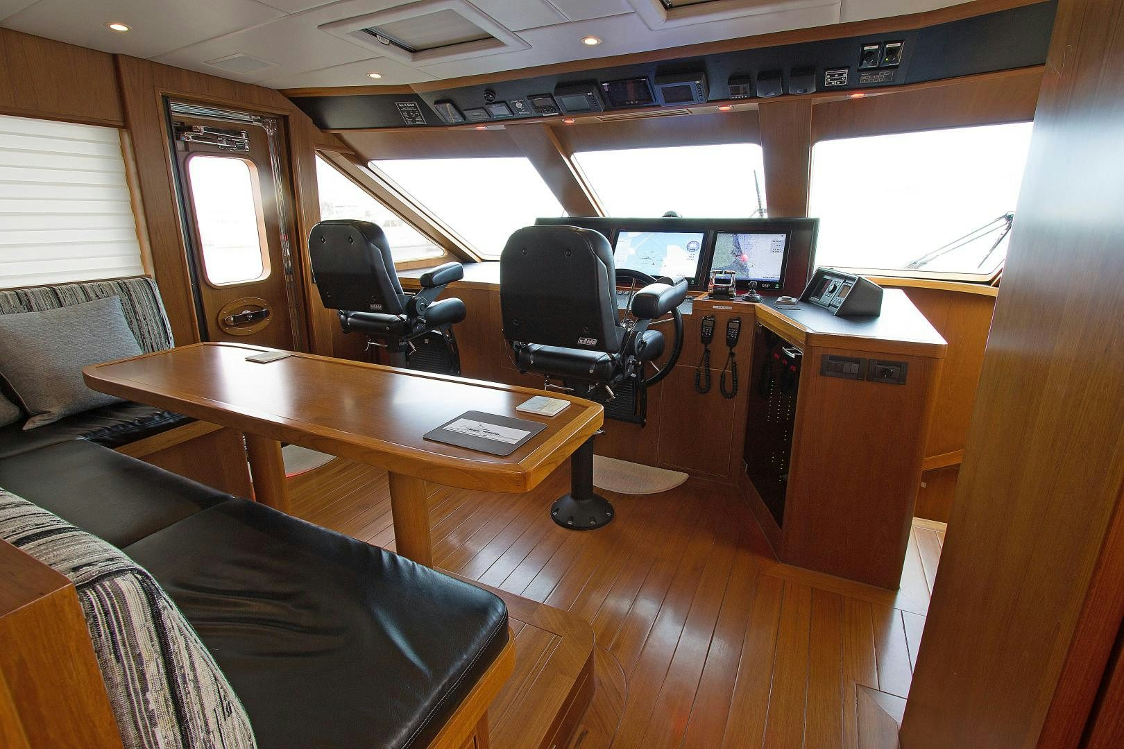 a room with a desk and chairs aboard LET IT BEE Yacht for Sale