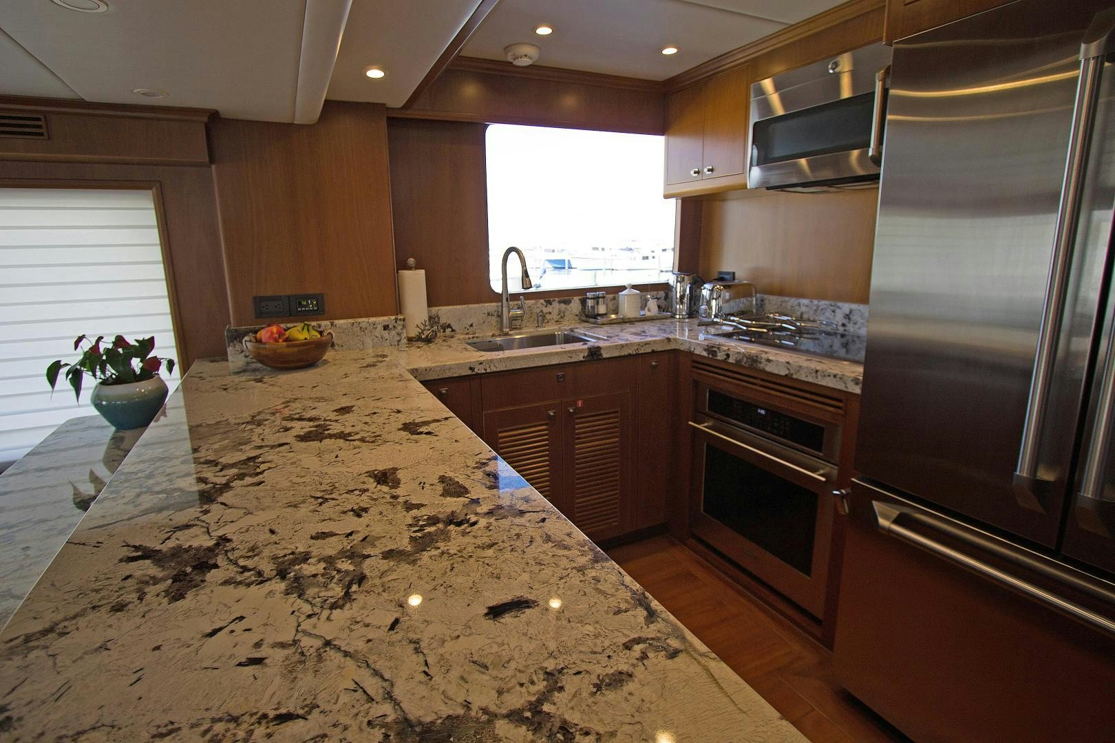 a large kitchen with stainless steel appliances aboard LET IT BEE Yacht for Sale