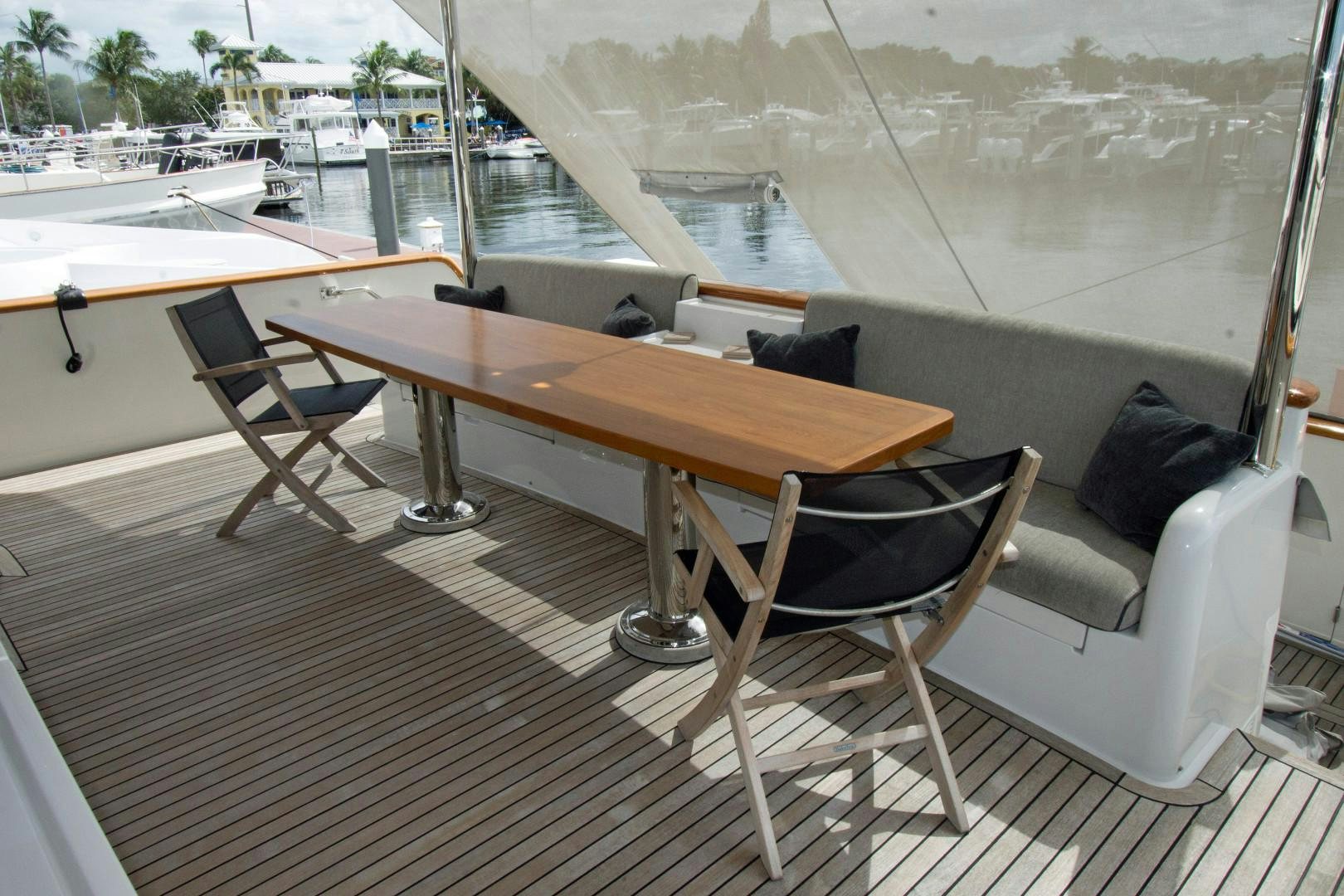 a table and chairs on a deck aboard LET IT BEE Yacht for Sale