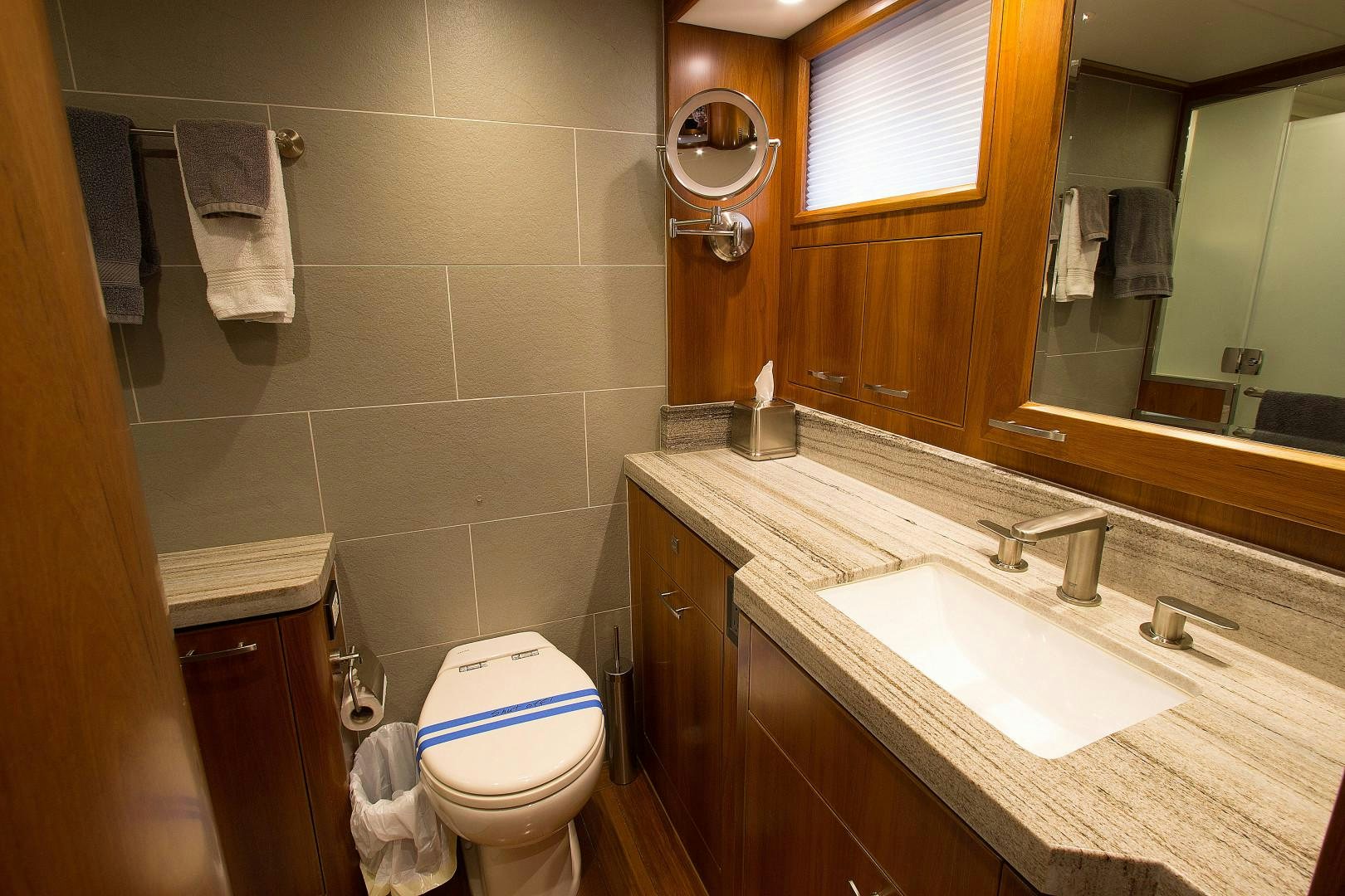 a bathroom with a toilet and sink aboard LET IT BEE Yacht for Sale