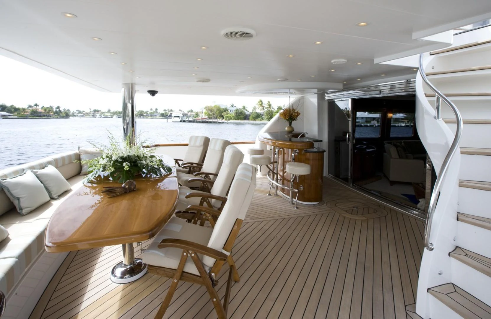 a room with a table chairs and a large window aboard SANDRINE Yacht for Sale