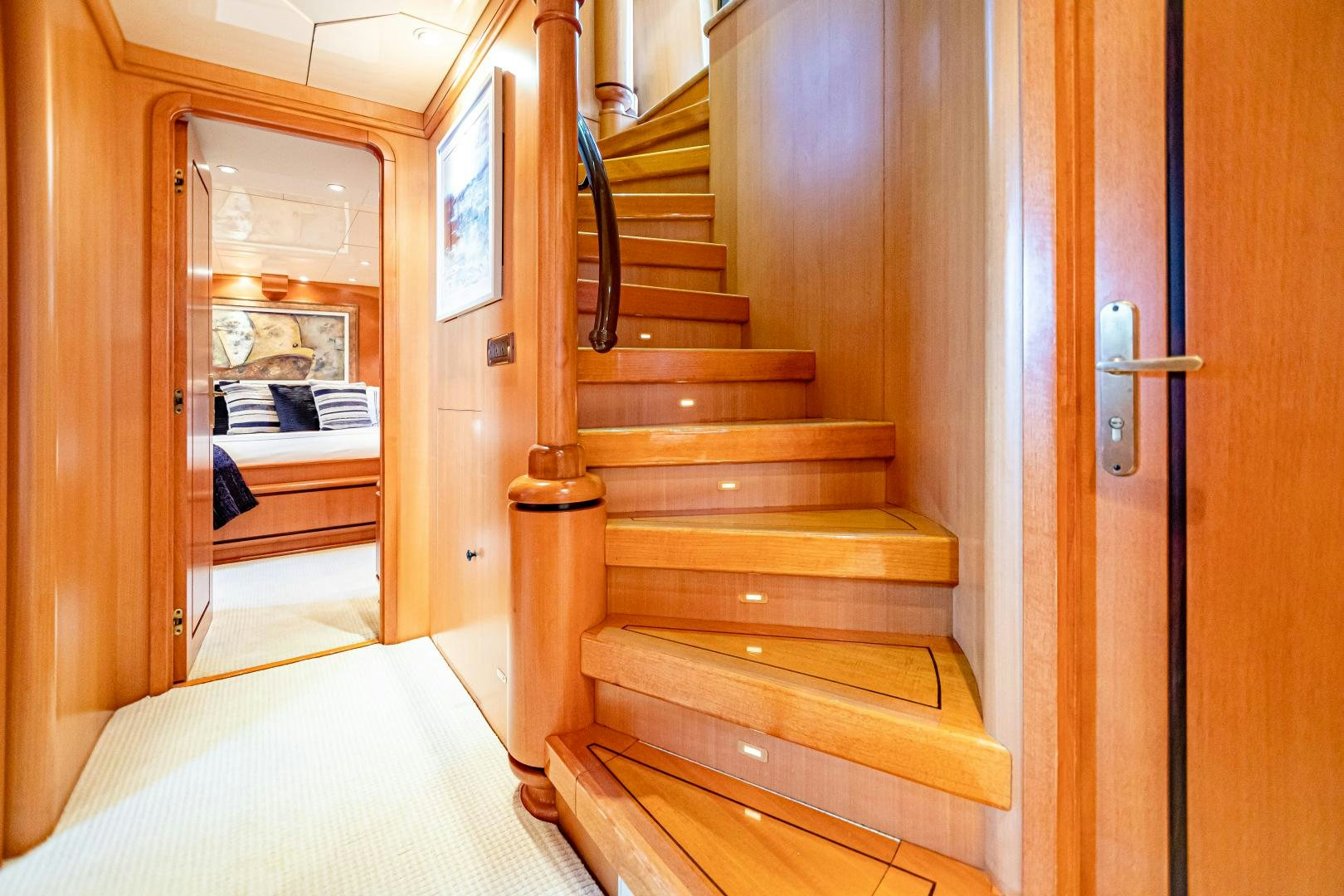 a wooden staircase in a room aboard XOXO Yacht for Sale